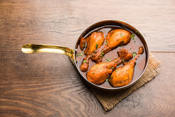 Chicken leg / drumstick curry or Murg Tangri/tangdi masala. Served in a bowl over moody background. Selective focus