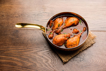 Chicken leg / drumstick curry or Murg Tangri/tangdi masala. Served in a bowl over moody background. Selective focus