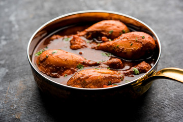 Chicken leg / drumstick curry or Murg Tangri/tangdi masala. Served in a bowl over moody background. Selective focus