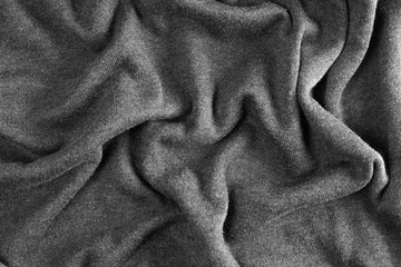 Crumpled grey fabric. The folds in the textiles. Negligence. Close up.