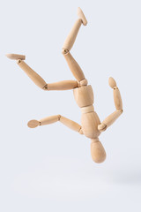 falling wooden mannequin isolated on white background