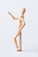 wooden mannequin with welcome gesture