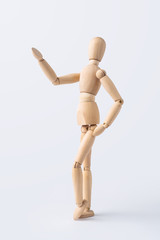 wooden mannequin with welcome gesture