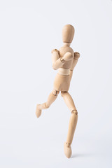 running wooden mannequin isolated on white background