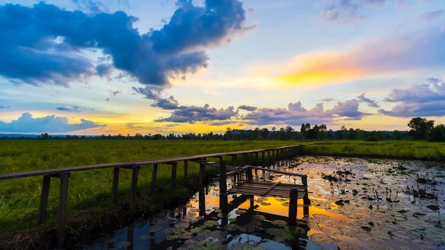 time lapse of 100 year-old wooden bridge with sunset at Khonburi, Nakhon Ratchasima, Thailand