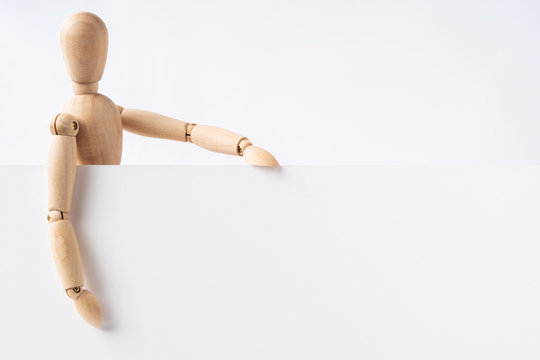 wooden mannequin hold empty board