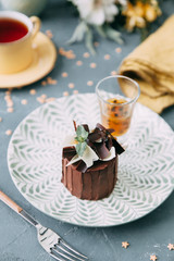 Crème brûlée with chocolate dessert with flowers. Foodstyling with tea on wooden background.