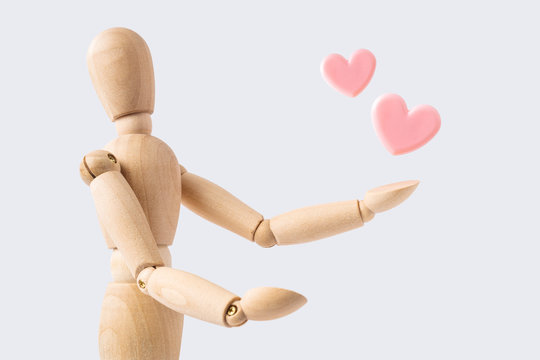 wooden mannequin with pink heart