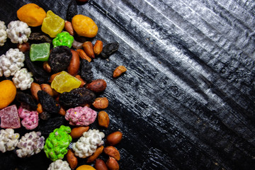 nuts and raisin on black background