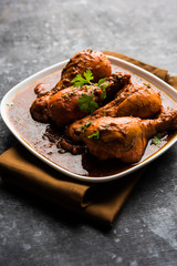 Chicken leg / drumstick curry or Murg Tangri/tangdi masala. Served in a bowl over moody background. Selective focus