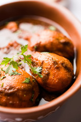 Chicken leg / drumstick curry or Murg Tangri/tangdi masala. Served in a bowl over moody background. Selective focus