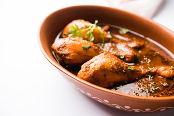 Chicken leg / drumstick curry or Murg Tangri/tangdi masala. Served in a bowl over moody background. Selective focus