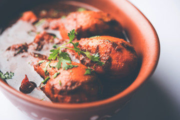 Chicken leg / drumstick curry or Murg Tangri/tangdi masala. Served in a bowl over moody background. Selective focus
