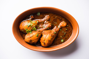 Chicken leg / drumstick curry or Murg Tangri/tangdi masala. Served in a bowl over moody background. Selective focus
