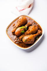 Chicken leg / drumstick curry or Murg Tangri/tangdi masala. Served in a bowl over moody background. Selective focus