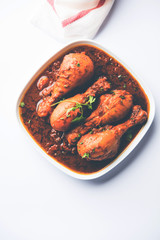 Chicken leg / drumstick curry or Murg Tangri/tangdi masala. Served in a bowl over moody background. Selective focus