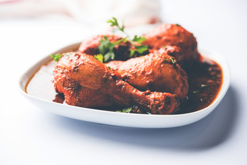 Chicken leg / drumstick curry or Murg Tangri/tangdi masala. Served in a bowl over moody background. Selective focus