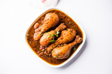 Chicken leg / drumstick curry or Murg Tangri/tangdi masala. Served in a bowl over moody background. Selective focus