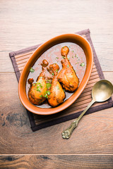 Chicken leg / drumstick curry or Murg Tangri/tangdi masala. Served in a bowl over moody background. Selective focus