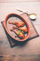 Chicken leg / drumstick curry or Murg Tangri/tangdi masala. Served in a bowl over moody background. Selective focus