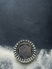 Baking accessories on black background with flour. Christmas winter dark background