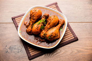 Chicken leg / drumstick curry or Murg Tangri/tangdi masala. Served in a bowl over moody background. Selective focus