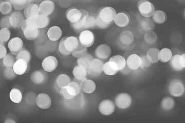 Gray blurred abstract background with light bokeh circles.