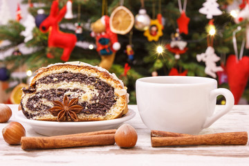 Poppy seeds cake, spices, hot coffee or tea and christmas tree with decoration, Christmas time concept