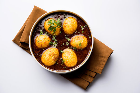 Fried egg curry or anda masala served in a bowl. selective focus