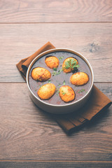 Fried egg curry or anda masala served in a bowl. selective focus