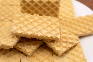 Belgian waffles with honey and cranberries on blue plate. Selective focus .
