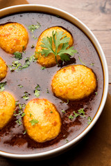 Fried egg curry or anda masala served in a bowl. selective focus
