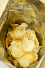heap of potato crisps on white background .