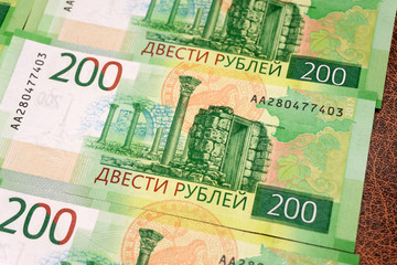 Fototapeta na wymiar Set of new russian banknotes on white background. 200 rubles. Sevastopol. Russian money.