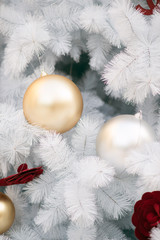 White Christmas decoration with Red balls and Silver balls on Christmas tree with blurred background.