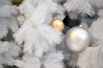White Christmas decoration with Red balls and Silver balls on Christmas tree with blurred background.