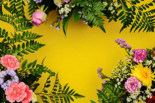 Floral picture frame concept. Placed on a yellow background to enter text.