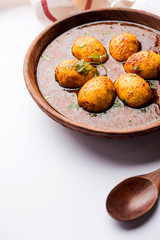 Fried egg curry or anda masala served in a bowl. selective focus