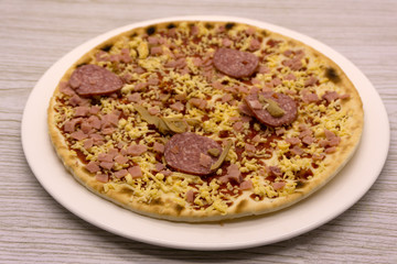 A frozen pepperoni pizza on a wood cutting board .