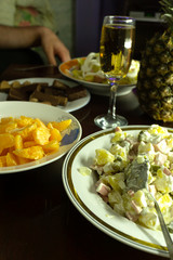 Group of people sitting at festive table and eating .