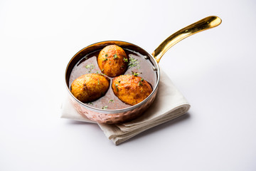 Fried egg curry or anda masala served in a bowl. selective focus