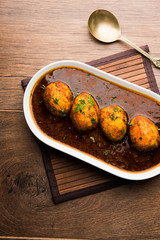 Fried egg curry or anda masala served in a bowl. selective focus