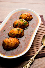 Fried egg curry or anda masala served in a bowl. selective focus