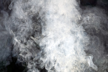 White smoke on a black background gray image .