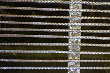 Steel grid over rare green grass