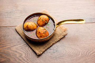 anda/egg curry with tangri/tangdi chicken masala. served in a serving pan. selective focus