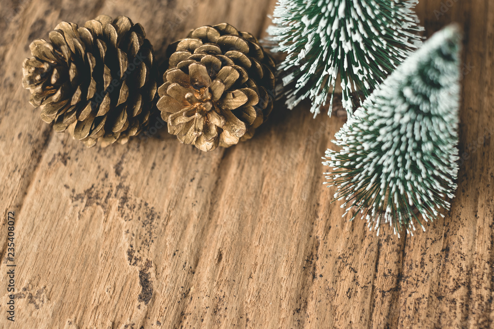 Aufkleber top view of christmas tree and gold pine cone on grunge wood table.winter holiday greeting card.leav