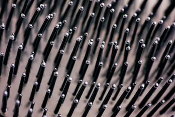 Close-up of bristles on black hairbrush.
