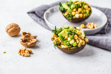 Avocado halves stuffed with avocado, nuts and chickpeas.