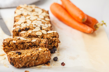 Vegan carrot bread with almonds on a white background.